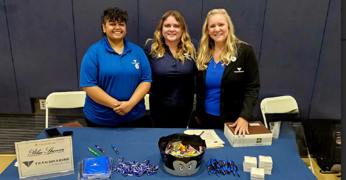 Transmarine employees standing behind a booth at the California Maritime Academy’s 2024 Fall Career Fair